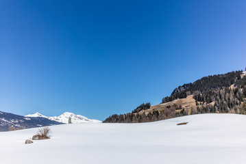 Fototapeta na wymiar Empty and deserted ski slopes during the corona virus lockdown in the Swiss Alps