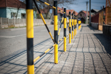 Protective yellow fence for pedestrians in front of the school