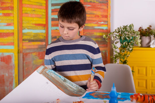Boy creating artwork at home.