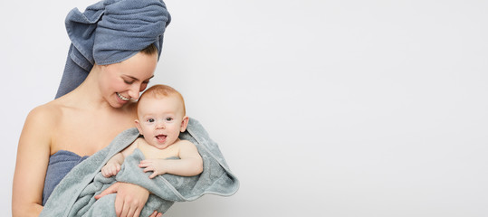 Healthy and pretty mother with her sweet baby having a loving moment
