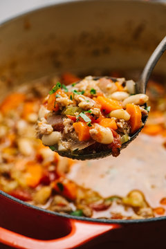 Spoon presentation detail of Italian sausage and white bean soup