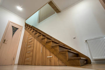 Modern architecture interior with luxury hallway with glossy wooden stairs in multi-storey house....