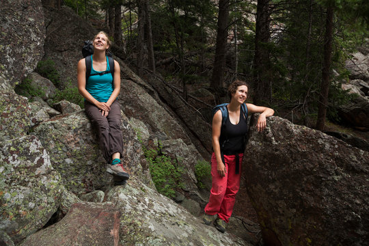 Women relax among rock boulders in Flatirons near Boulder, Colorado
