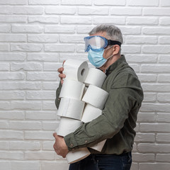 Man with many rolls of toilet paper during quarantine