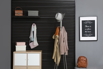 Hallway interior with stylish furniture, clothes and accessories