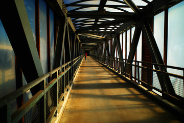 Fototapeta na wymiar Man crossing city bridge during sunset time background