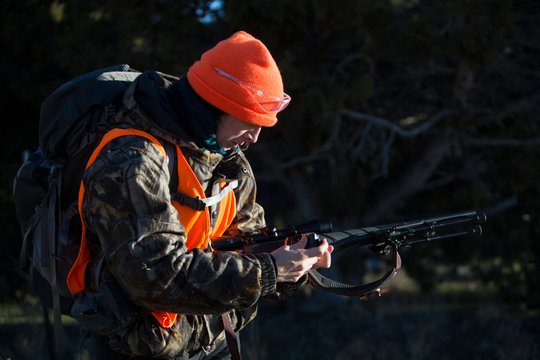 Female hunter loads her gun in Paonia, Colorado