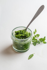 pesto sauce in a jar take a spoon. Close shot