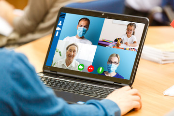 Cropped image of cheerful blogger having funny conversation with best friend in video chat on modern touchpad connecting to wireless 4G internet.Young man sharing impressions of trip on webcam