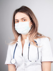 A woman doctor at work in a hospital is excited and happy with her profession. Brunette woman doctor Concept of medicine and health care