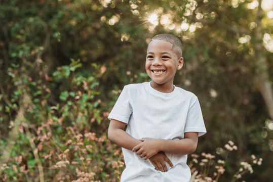 Close uo portrait of young school-aged confident boy smiling outside
