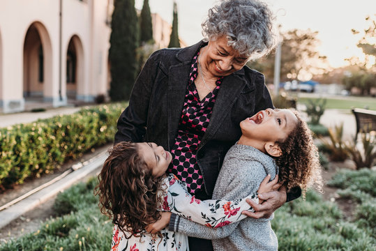Close up lifestyle image of grandmother and grandchildren laughing