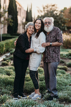 Portrait of active senior married couple and adult daughter smiling