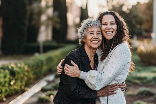 Portrait of active senior grandmother and adult daughter smiling