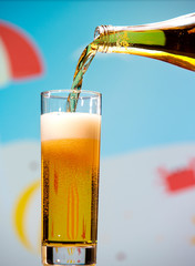 Pear carbonated drink pours from a bottle into a glass