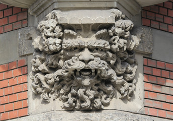 Eroded Corbel of an oriel window - display of an imaginary face, details of classic European...