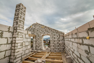 Building site of a house under construction made from white foam concrete blocks.