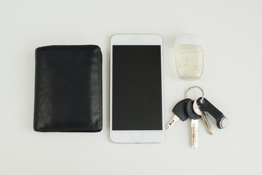 Items that are primarily in need of disinfection against coronavirus. Phone, keys, wallet and antiseptic - a reminder for wiping with a sanitizer from germs and bacteria.