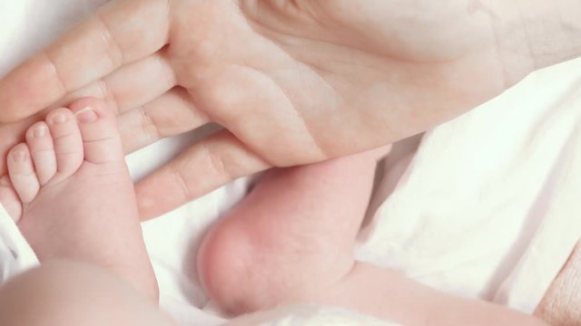 A close-up of tiny baby feet
