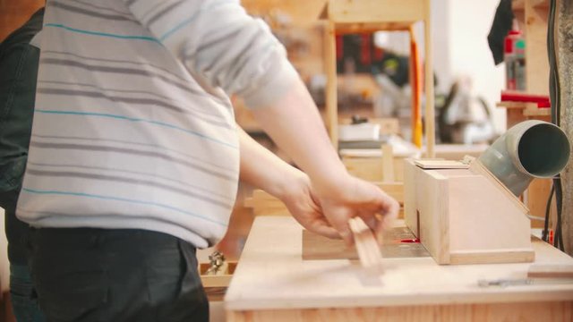 Carpentry working - two men workers working with plywood