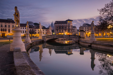 Padova mirrored in the garden of square of Prato della Valle, Italy.