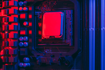 Hardware technology concept in neon light. Motherboard in blue-red light. Computer accessories....