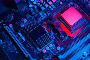 Hardware technology concept in neon light. Motherboard in blue-red light. Computer  component. Dark...