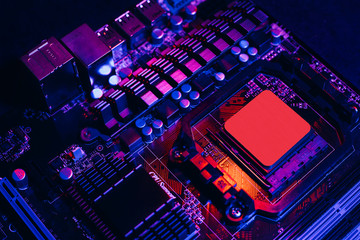 Hardware technology concept in neon light. Motherboard in blue-red light. Computer  component. Dark...