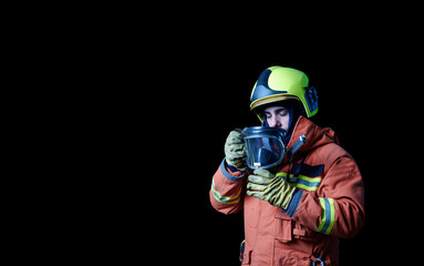 firefighter sadly putting on protective gear