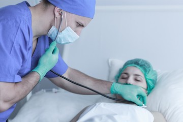 Doctor examining patient after operation