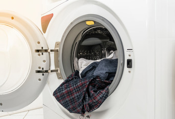 Close up view of a washing machine full of clothes
