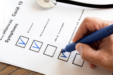 hand with pen completing form