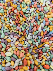 many multi-colored seeds for eating like a background
