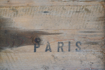 Paris stamp paint word letters on wood transport box vintage wooden background