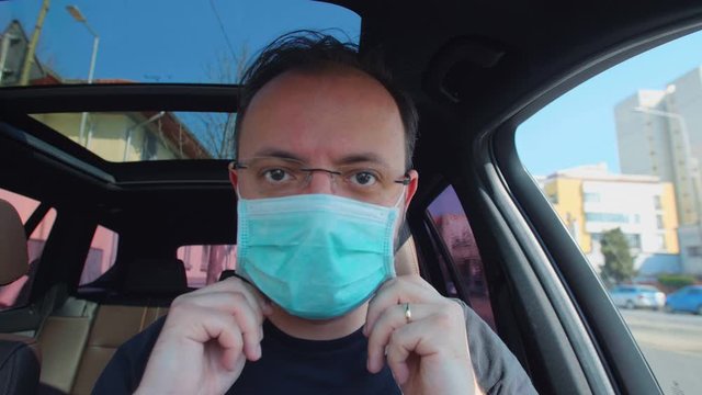 Portrait Of A Man Putting On His Medical Mask. Man Prevent Coronavirus Contamination Wearing Mask All Time.