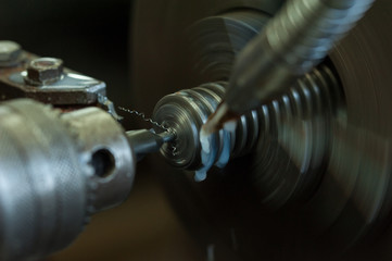 Finishing metal working internal steel surface on lathe grinder. Metalworking industry