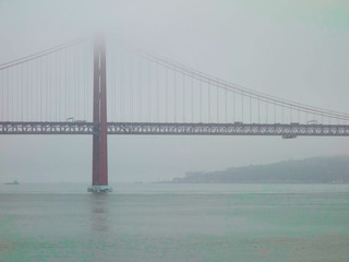 Lisbon, Portugal-23 December 2019. Bridge on 25 April 2019 crossing the river Tejo on a foggy day.
