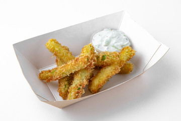 Sliced zucchini or asparagus in batter with tartar sauce package for take away or food delivery isolated on a white background.