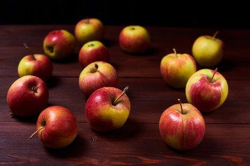 Fresh red-green apples on a wooden background.