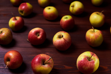 Fresh red-green apples on a wooden background.