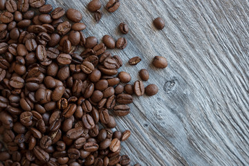 Coffee beans on a wooden table, top view.