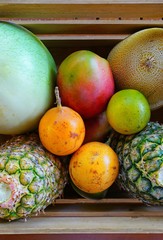 Crate of fresh tropical fruit including pineapple and mango