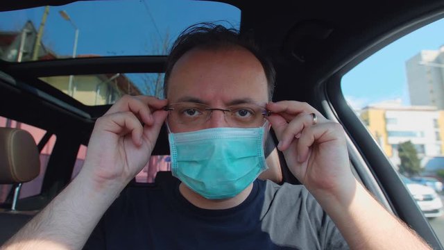 Portrait Of A Man Putting On His Medical Mask. Man Prevent Coronavirus Contamination Wearing Mask All Time.