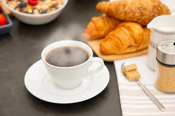 Breakfast Served in the morning with Hot black coffee and croissants Natural corn flake breakfast cereal in cups and fruit on the breakfast table every day