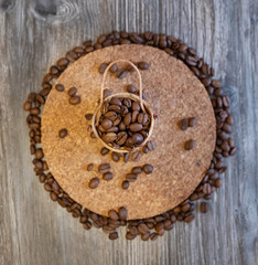 Grain coffee beans in a wooden chest, on a wooden table.