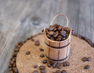 Grain coffee beans in a wooden chest, on a wooden table.