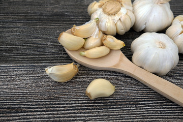 garlic grains on wooden background, close up,