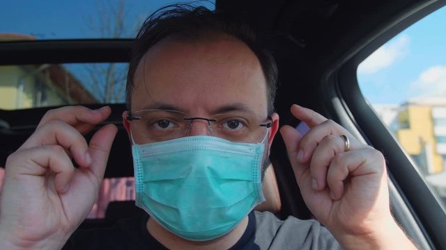 Portrait Of A Man Putting On His Medical Mask. Man Prevent Coronavirus Contamination Wearing Mask All Time.