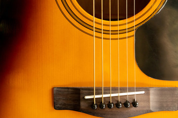 Obraz premium Close up of an acoustic guitar bridge pin and close up of guitar strings