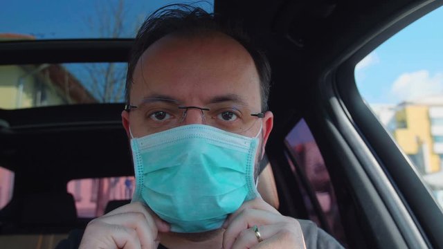 Portrait Of A Man Putting On His Medical Mask. Man Prevent Coronavirus Contamination Wearing Mask All Time.